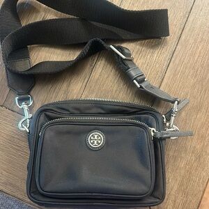 Tory Burch adjustable nylon crossbody bag in black with silver hardware.